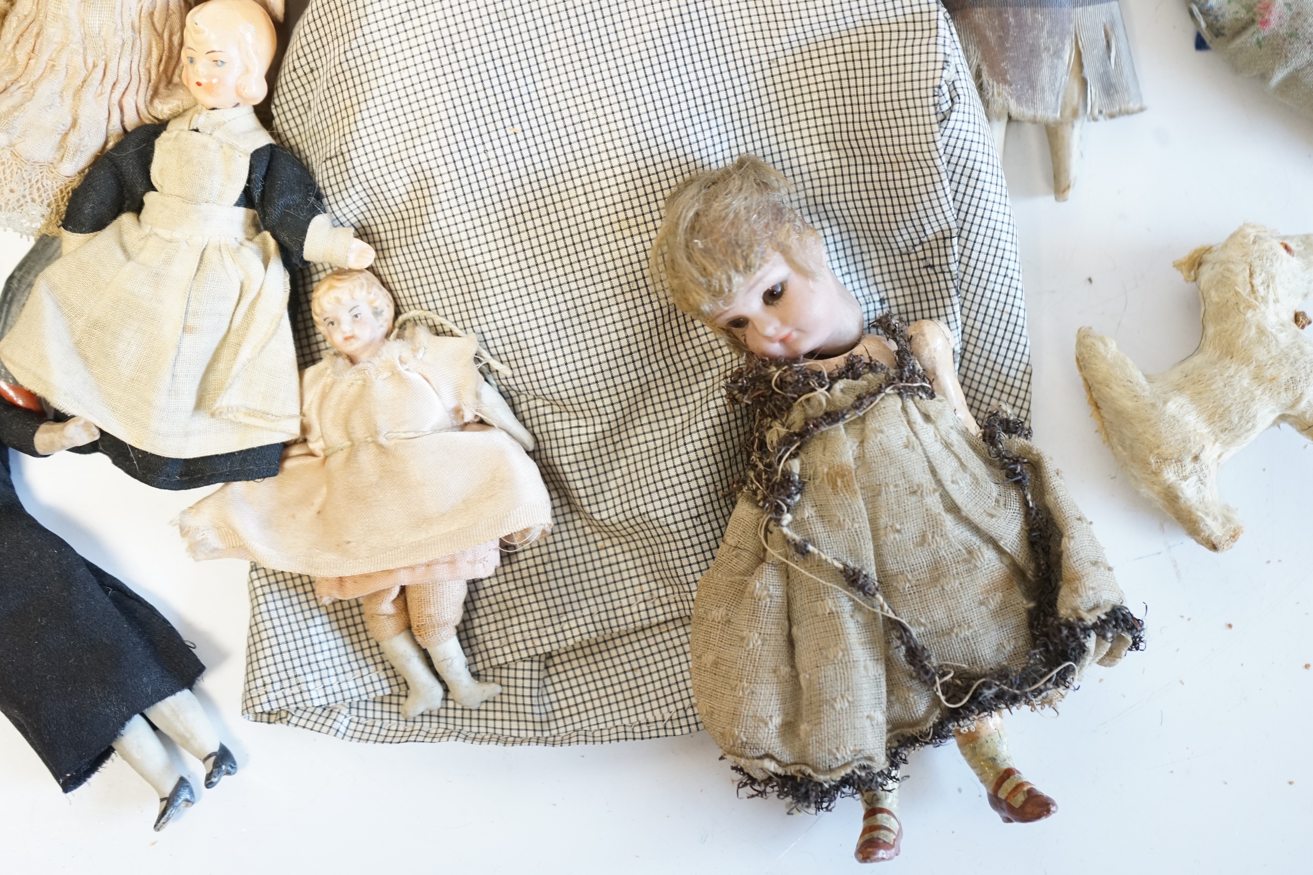 Eleven doll's house dolls, 19th and early 20th century, including two Kammer & Reinhardt bisque jointed dolls and a wax over composition doll in original clothes (12). Condition - fair